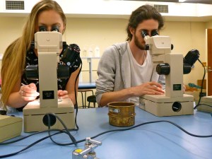 Allison and Tommy looking into the microscopes searching for foraminifera